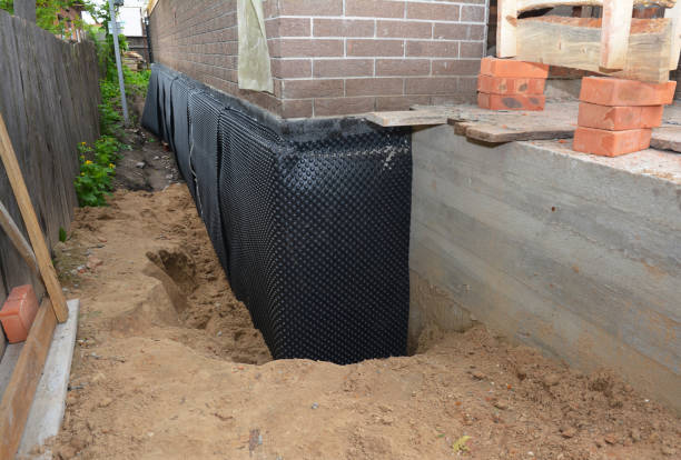 Happy homeowners after waterproofing job in Pitman